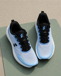 Pair of Silwer Active Ice Blue Men's Shoes at an angle, on a green mat over a concrete surface