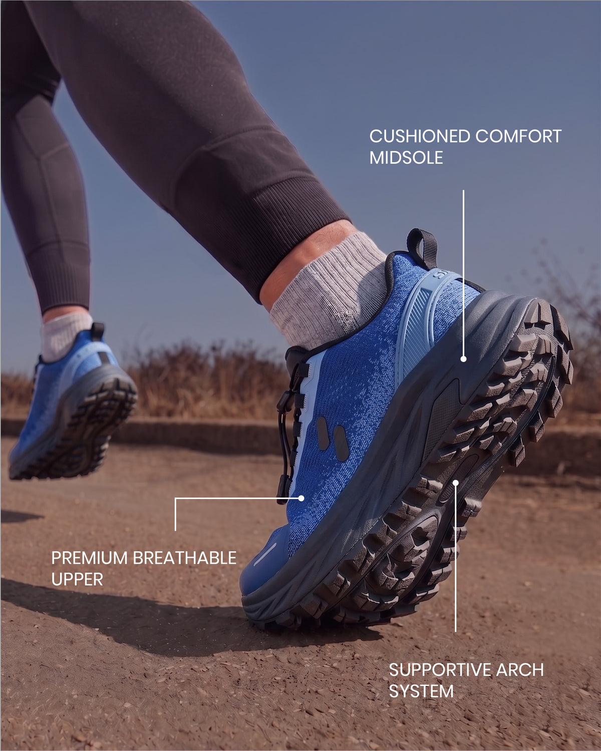 Man's foot mid-stride wearing a Silwer Active Ink Blue Men's Shoe outdoors, with callouts for the cushioned comfort midsole, breathable upper, and supportive arch system