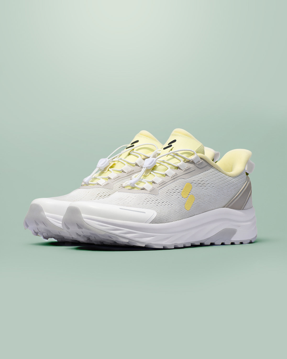 Silwer Active Lime White Men's Shoes, pair shown at a three-quarter angle, grey mesh upper with lime accents, on a green background