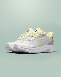 Silwer Active Lime White Men's Shoes, pair shown at a three-quarter angle, grey mesh upper with lime accents, on a green background