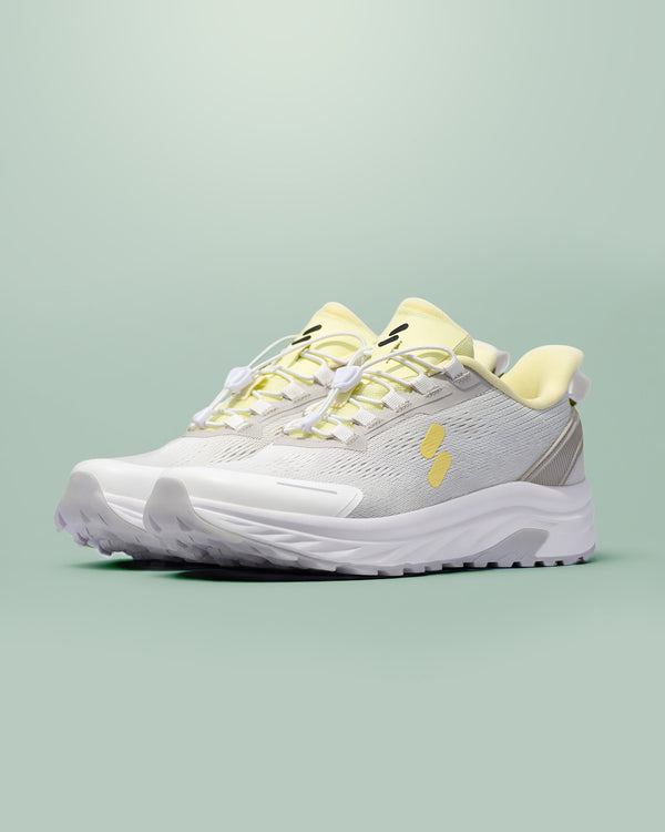 Silwer Active Lime White Men's Shoes, pair shown at a three-quarter angle, grey mesh upper with lime accents, on a green background