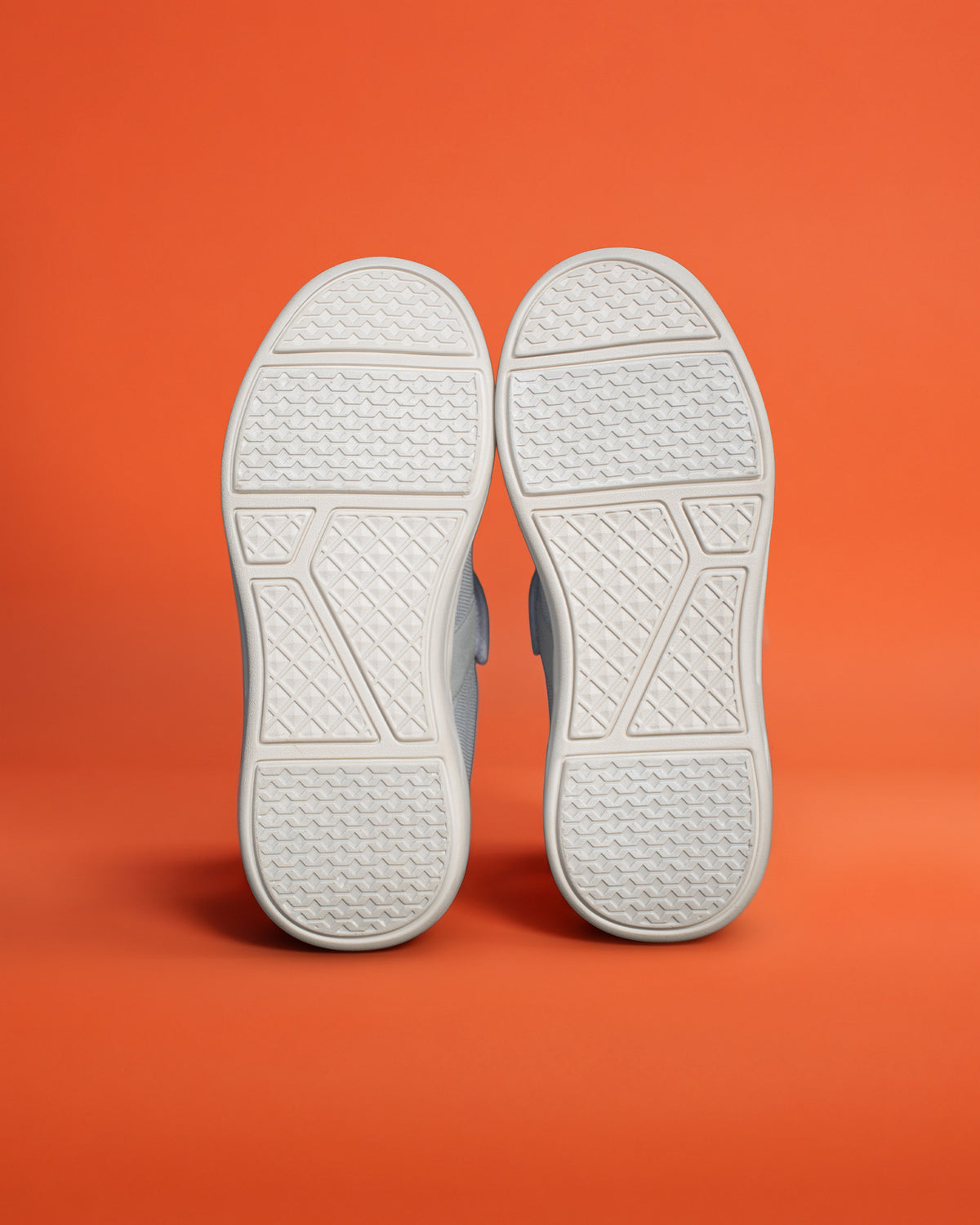 Pair of Silwer Ease Castle Grey Men's Shoe outsoles, showing the textured tread pattern