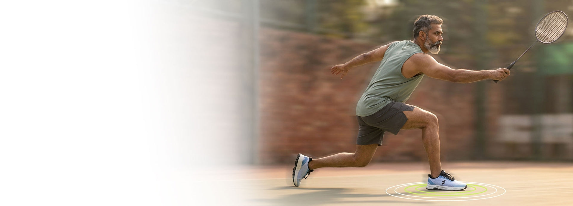 Man playing badminton on an outdoor court wearing Silwer Active  Ice Blue shoes